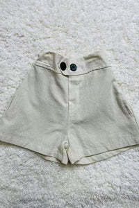 Beige cotton girls short w/black button 230121M
