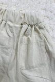 Beige cotton girls short w/black button 230121M