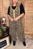 Person wearing leopard print overalls with a black top in a festive indoor setting.