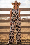 Woman wearing a leopard print outfit with a cowboy hat in a rural setting.